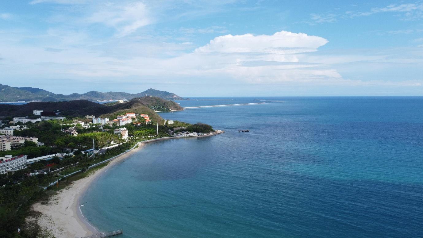 A beach with buildings and a body of water AI-generated content may be incorrect.