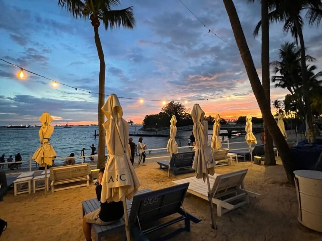 Couples enjoy Sentosa Siloso Beach countdown party vibes.