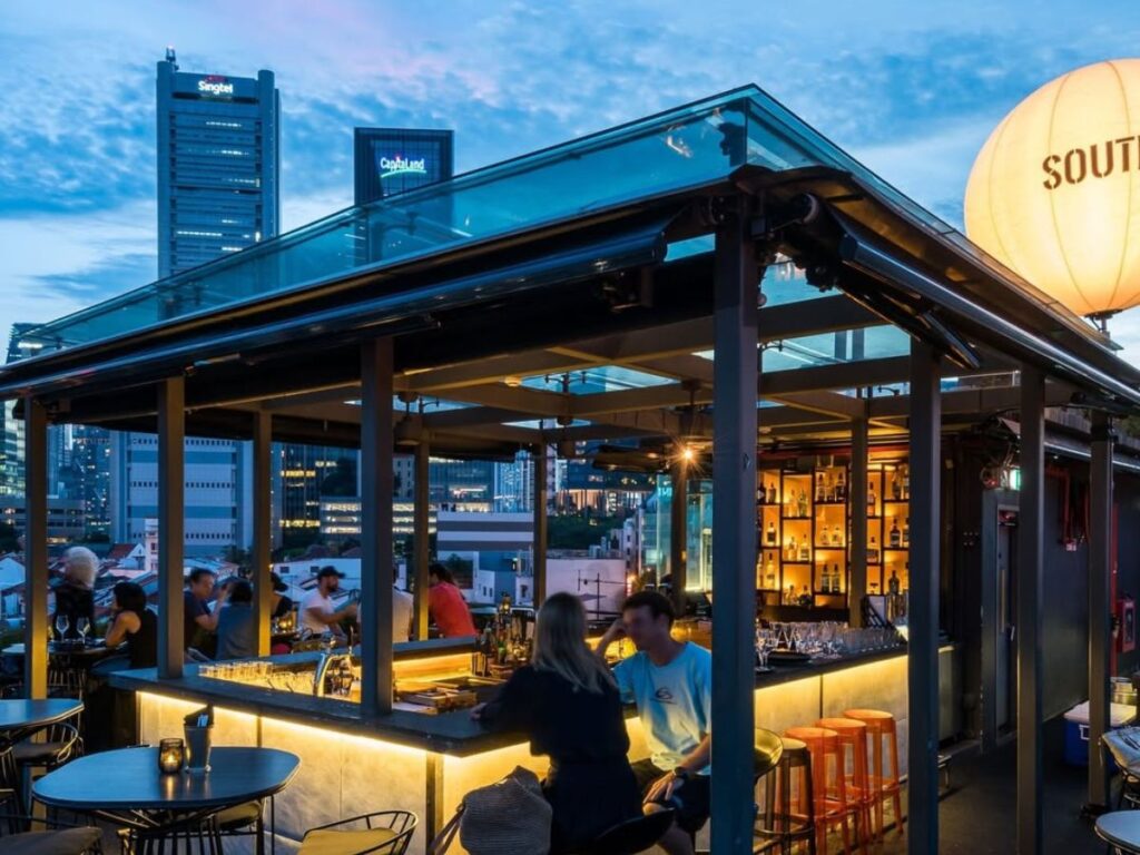 Couples enjoy the best rooftop bars for countdown Singapore at Southbridge.
