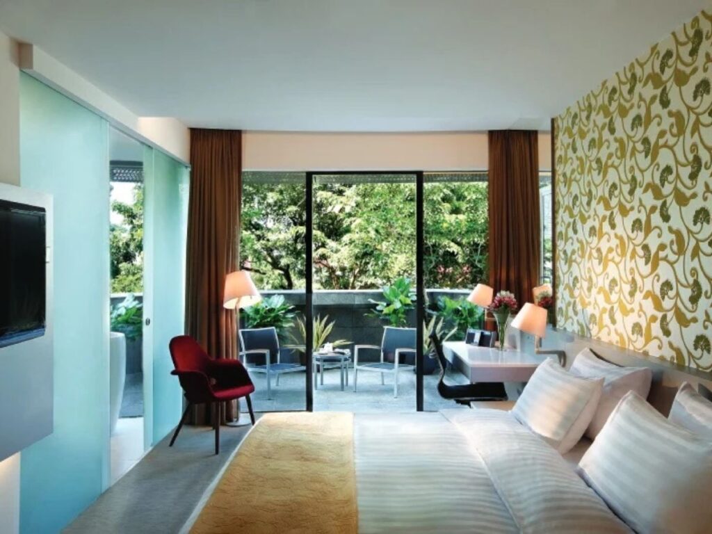 Couples enjoying a staycation at D’Hotel Singapore one of the best places to go in Tiong Bahru for couples